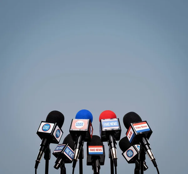 Microphones Prepared Press Conference Mic Flags Displaying Fake News Logos — Stock Photo, Image