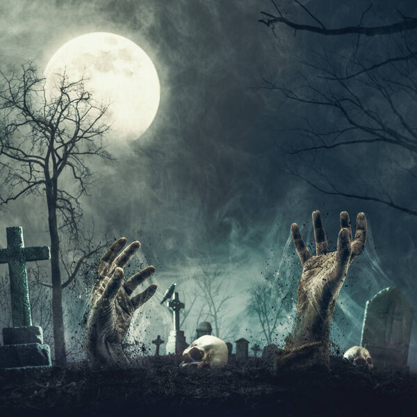 Creepy zombies rising from their graves in the cemetery, horror and Halloween concept