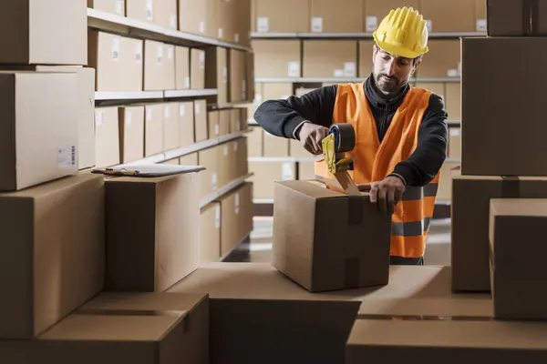 Trabalhador Armazém Selando Uma Caixa Papelão Com Fita Adesiva Logística — Fotografia de Stock