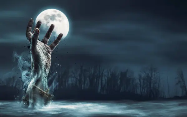 Creepy dirty zombie hand rising in the night sky surrounded by fog, horror and Halloween concept