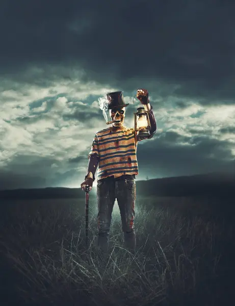 Evil scary character with skull head standing in the fields and holding a lantern