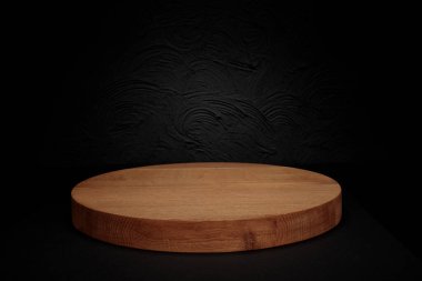 Wooden podium or pedestal display on dark background with cylinder stand concept. Blank product shelf standing backdrop