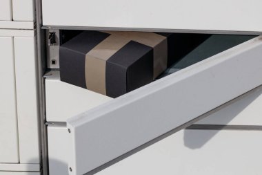 Close-up of a parcel placed in a parcel machine, the courier company's automatic delivery box.