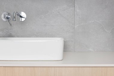 Close-up on a washbasin with free space for product presentation. MOCKUP, eye-level view.