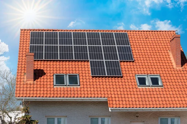 Solar panels installed on the roof of a modern house