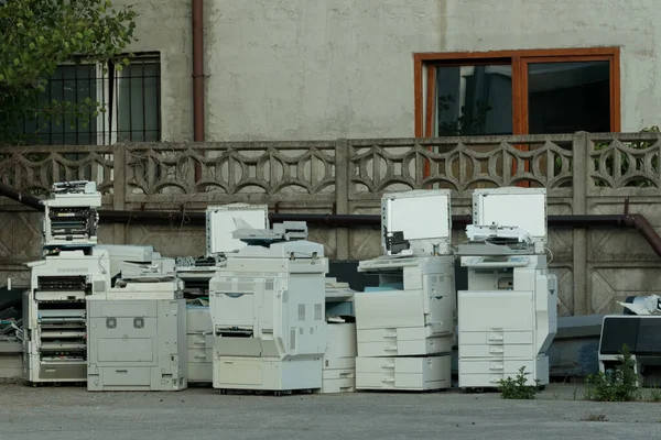 Problem with e-waste: heap of old printers, xerox equipment