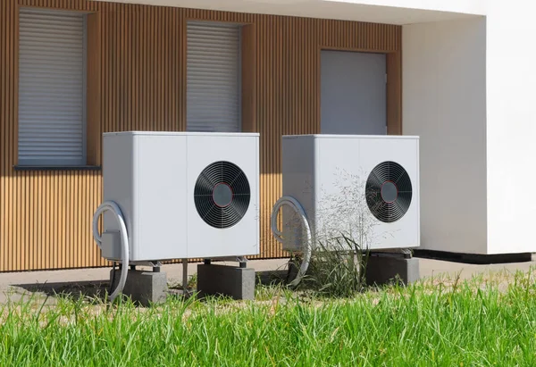 Dual Eco Friendly Air Source Heat Pumps Contemporary Residence Royalty Free Stock Images