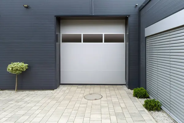 stock image Industrial Garage Door with Small Tree