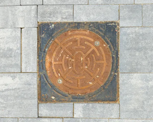 stock image Rusty Manhole Cover on Pavement