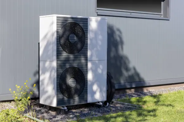 stock image Heat pump unit installed outside a modern building