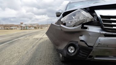 Close-Up of Damaged Front Car Bumper After Accident clipart