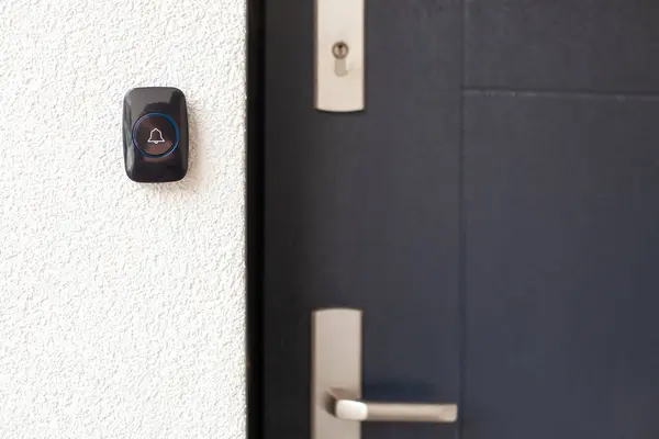 stock image Black Doorbell on White Wall by Dark Door