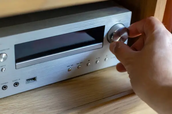 stock image Hand Adjusting Volume on Audio Receiver