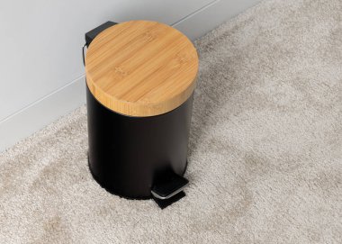 Black Pedal Trash Can with Bamboo Lid on Carpet