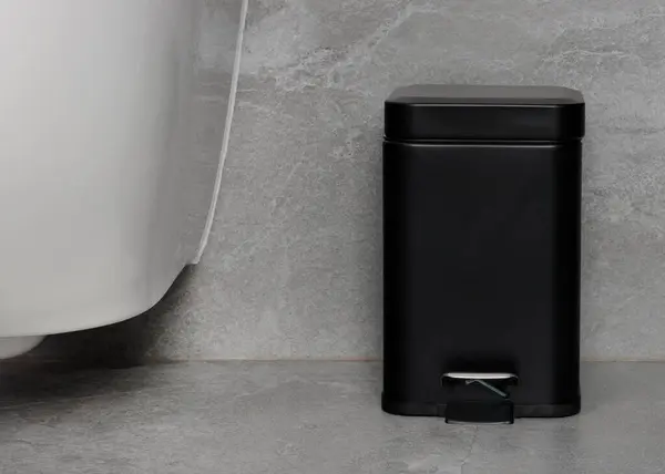 stock image Compact Black Pedal Trash Bin in Minimalist Bathroom