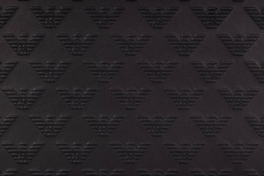 Poznan, Poland. 3 June, 2024. Embossed Emporio Armani Logo Pattern on Black Leather clipart