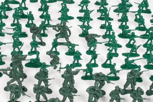 stock image Green plastic toy soldiers on white background