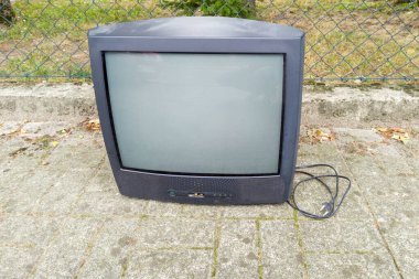 Old CRT Television Set Placed on Sidewalk clipart