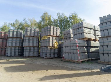 Stacked materials for curb construction at building site clipart