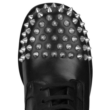 Close up of black boot toe with silver studs clipart