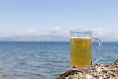 Deniz kenarındaki soğuk bira bardağı.