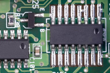 Integrated circuits on green circuit board clipart