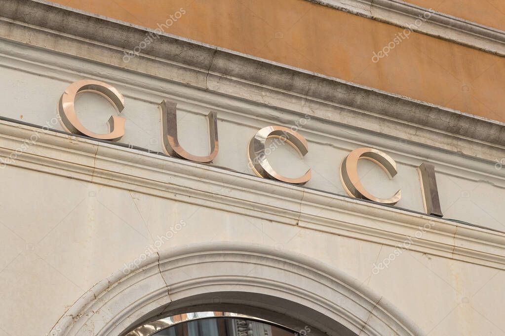 Venice, Italy - April 20 2025: Gucci boutique logo on historic building facade in Venice