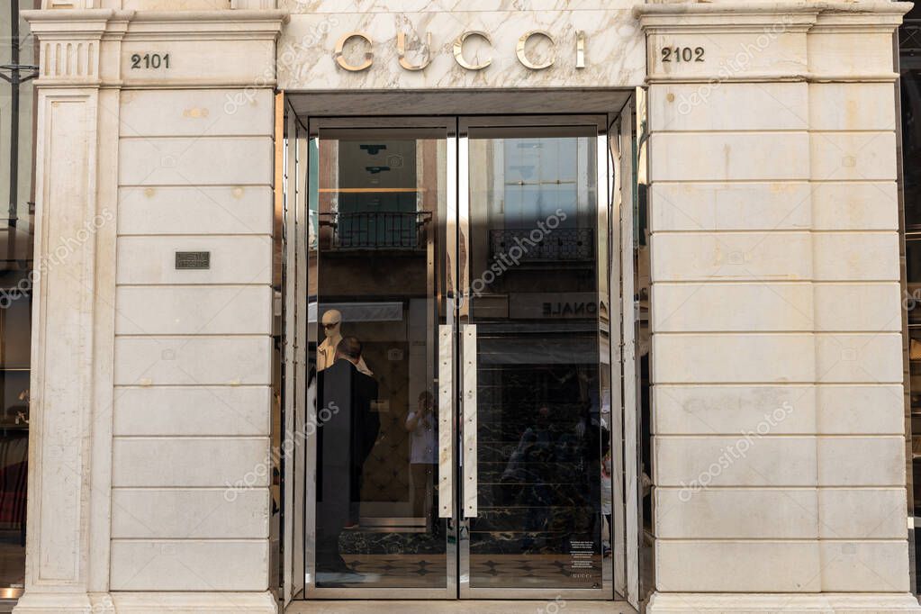 Venice, Italy - April 20 2025: Gucci boutique entrance with logo above mirrored glass doors