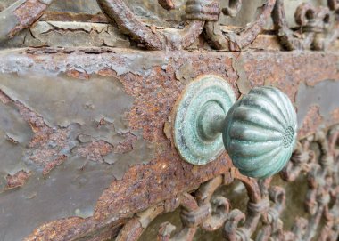 Paslı metal yüzeydeki eski dekoratif kapı tokmağı.