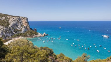 Tekneler ve kayalıklarla dolu derin mavi körfezin yüksek görüş açısı