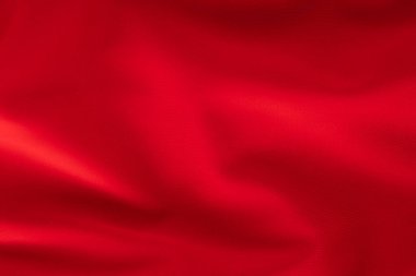 Yumuşak kıvrımlı parlak kırmızı kumaş, tekstil dokusu yakın çekim