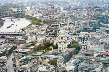 Expansive aerial view of central London featuring St. Paul Cathedral, the River Thames, and surrounding urban architecture and landmarks. clipart