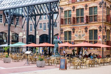 Groningen, The Netherlands - July 7, 2022: Restaurant and terrace near historic Goudkantoor - dutch for old office - building and Waagstraat complex