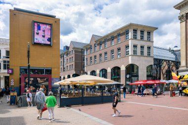 Groningen, The Netherlands - July 7, 2022: Restaurant and terrace with relaxing people near Grote Markt Plaza downtown medieval city Groningen