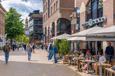 Groningen, The Netherlands - July 7, 2022: Restaurant and terrace with relaxing people near Grote Markt Plaza downtown medieval city Groningen