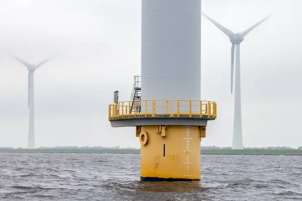 stock image Offshore windfarm near Dutch coast with cloudy sky. This park in the lake IJssselmeer near Urk is the biggest windfarm of the Netherlands