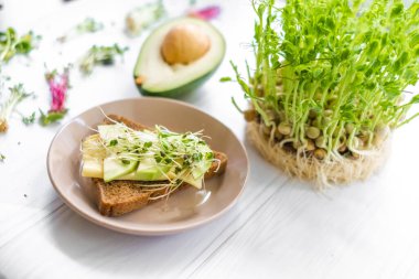 Peynirli sandviç ve tabakta çiğ yeşillik, sağlıklı kahvaltı, diyet.