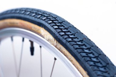 Close up of worn out bicycle tIre on white background. Bicycle tire sidewall damage