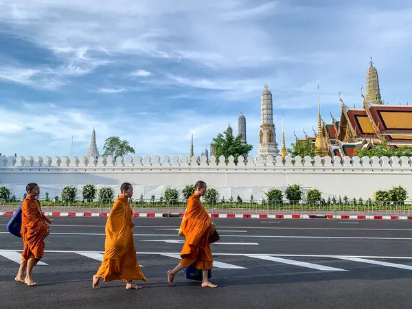 stock image Bangkok, Thailand - July 6, 2024: Each morning, just before dawn, Thai monks and novice can be seen walking barefoot along the streets, carrying their alms bowls in peace