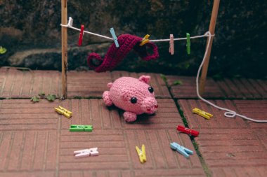 knitted pink minipig opposite clothespins and things