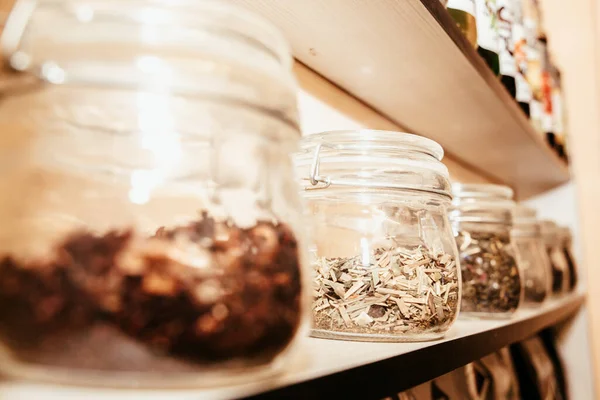 stock image different glass jars with marshmallows and chocolate on a shelf in a cafe