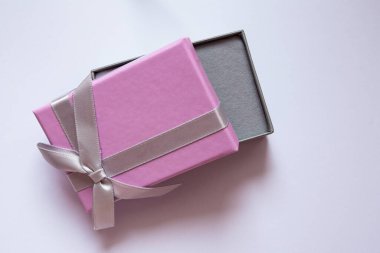 Gri kurdeleli küçük pembe hediye kutusu, kutunun fotoğrafı, hediye.