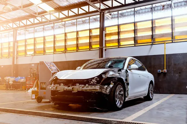 stock image Car in autoservice. Electric car repair station with soft-focus and over light in the background. EV car maintenance