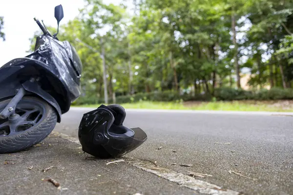 Yolda kask takılı motosiklet kazası ve hayat kurtarma mesajı, yol güvenliği ve farkındalık kavramı