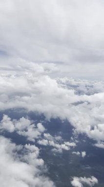 footage from an airplane window. Scenic view over beautiful white clouds and sky. Concept of freedom, travel, journey and transportation.