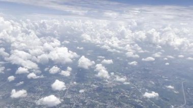 footage from an airplane window. Scenic view over beautiful white clouds and sky. Concept of freedom, travel, journey and transportation.