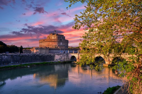 stock image Sunset view of bridge and Sant Angelo  castle and river Tiber in Rome. Italy.
