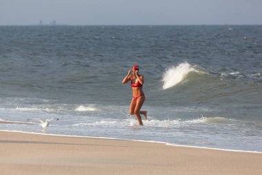 Sea Bright, New Jersey - August 3, 2017: Lifeguards from Sea Bright and surrounding beach clubs gather to compete in a lifeguard competition clipart