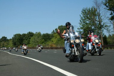 Holmdel, New Jersey - September 18, 2005: Motorcycles ride along the Garden State Parkway during the Rolling Thunder Ride for Freedom clipart