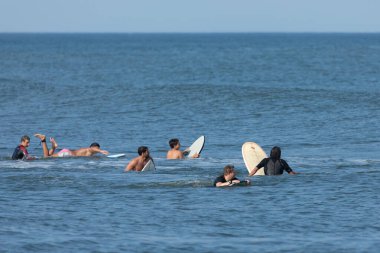 Deal, New Jersey - 10 Ağustos 2024: sörfçüler Debby Kasırgası 'nın kalıntılarında Deal açıklarında sörf yapıyor.